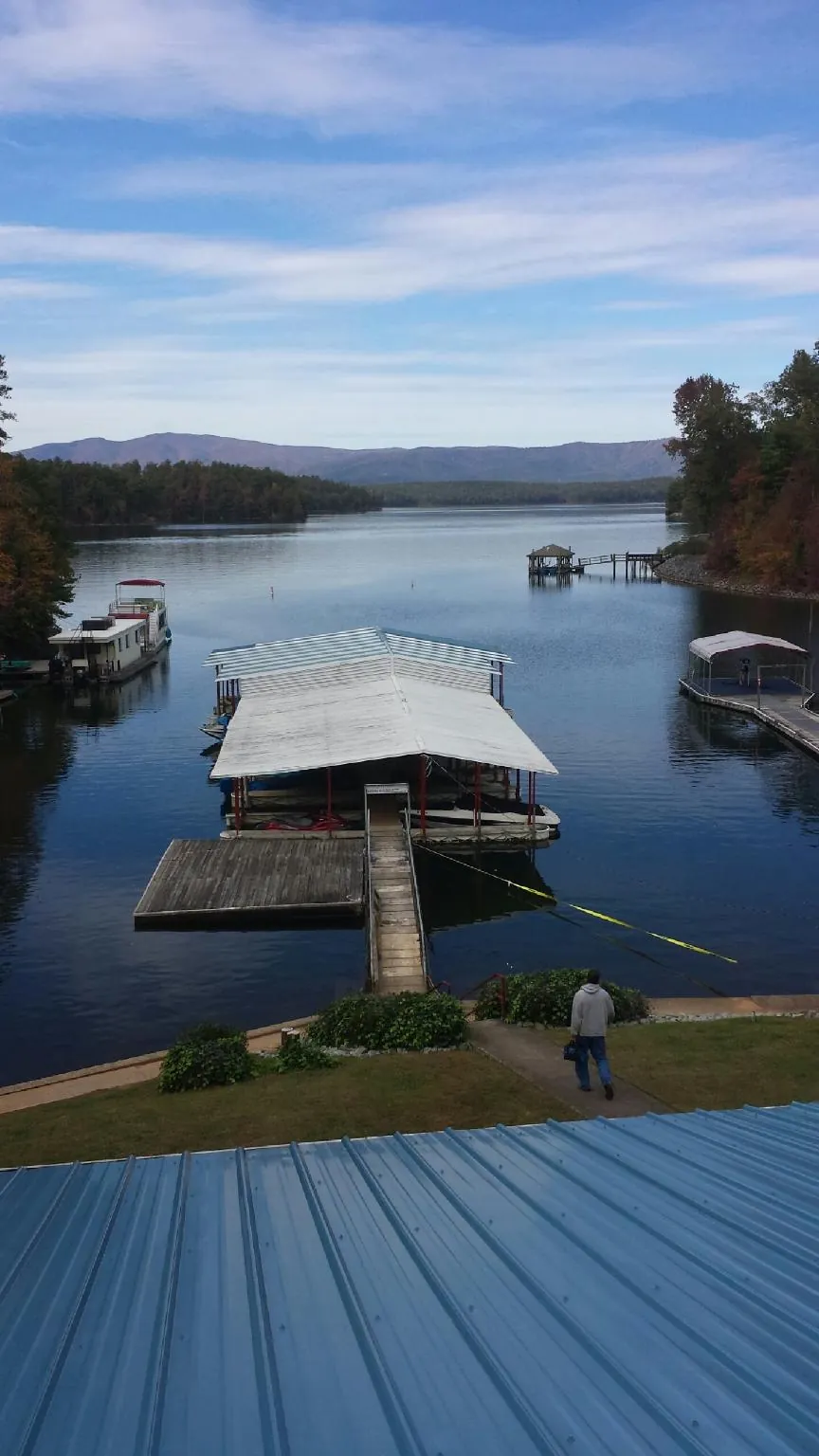 View across a lake from a newly installed blue metal roof in Dillsburg
