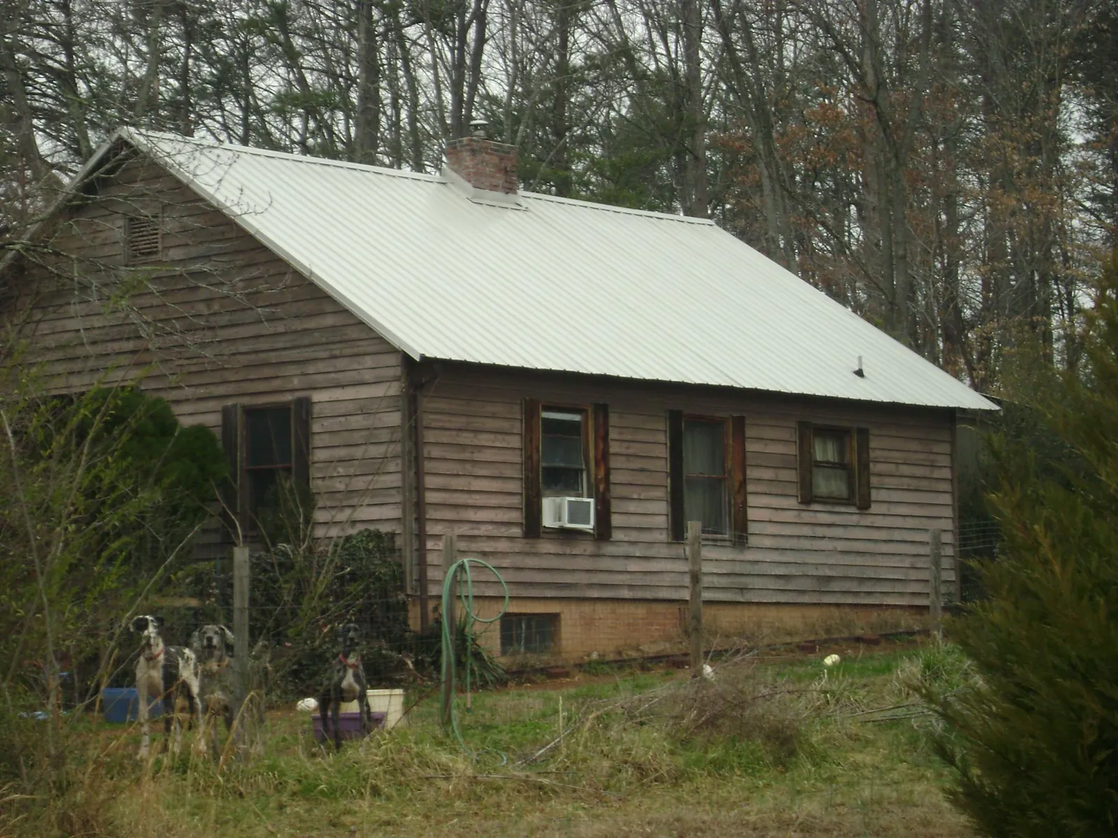 White metal roof on an old wood sided farmhouse, from a Metal Roof Installation job in Dillsburg